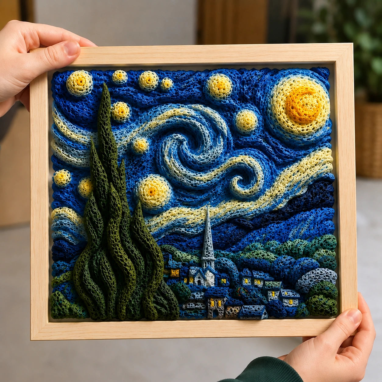 Framed blue and yellow artwork with raised swirls, stars and textured details.